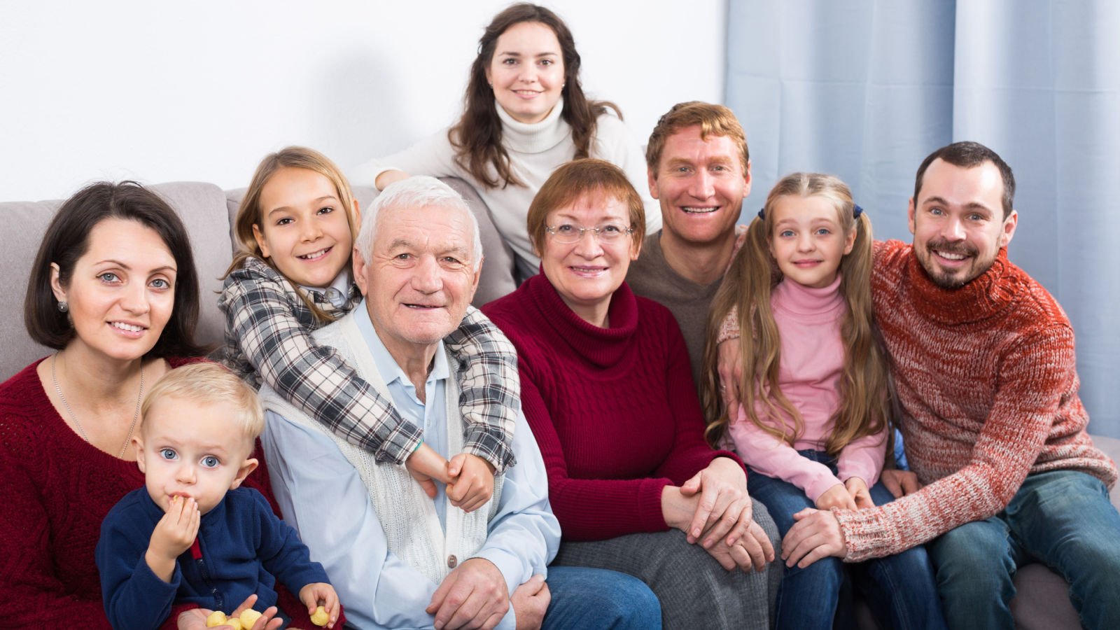 Laughing family making numerous photos during big family dinner bearfotos shutterstock