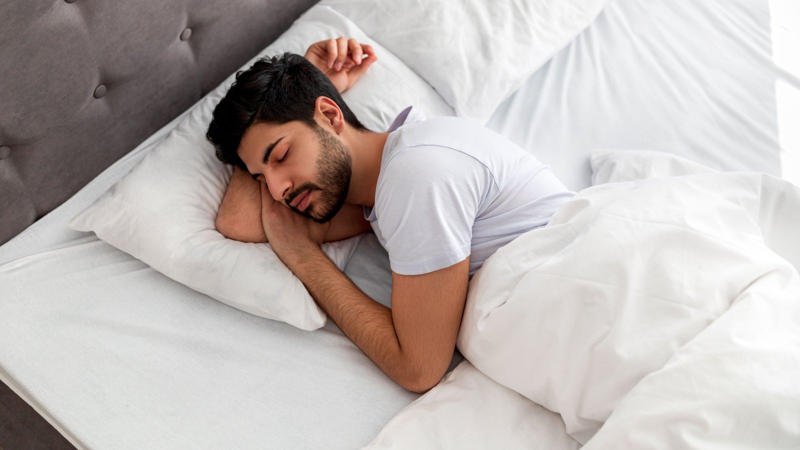 Male Sleeping sheets bed rest Prostock studio Shutterstock