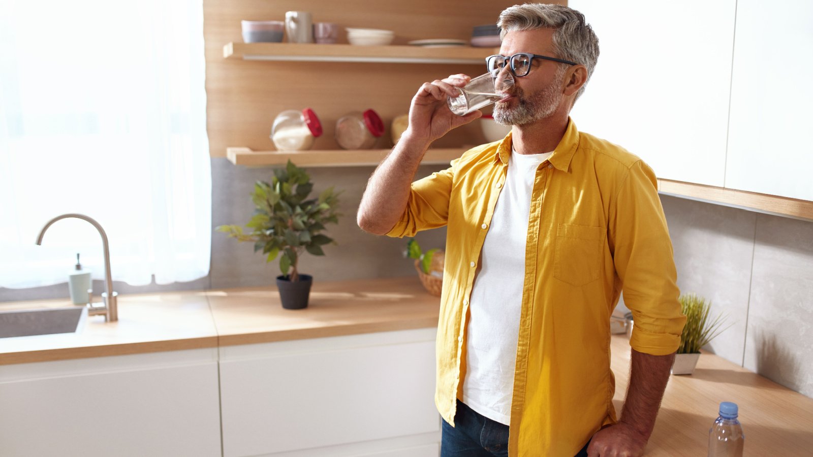 Male drinking water glass health hydration puhhha Shutterstock