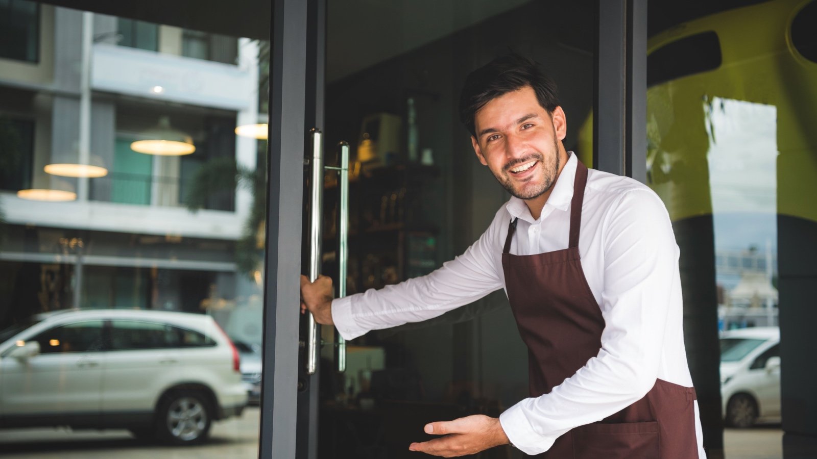 Male holding door open etiquette coffee shop Little Pig Studio Shutterstock