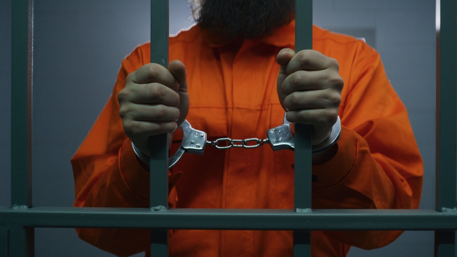 Male prisoner in jail wearing orange jumpsuit with handcuffs arrested Frame Stock Footage Shutterstock