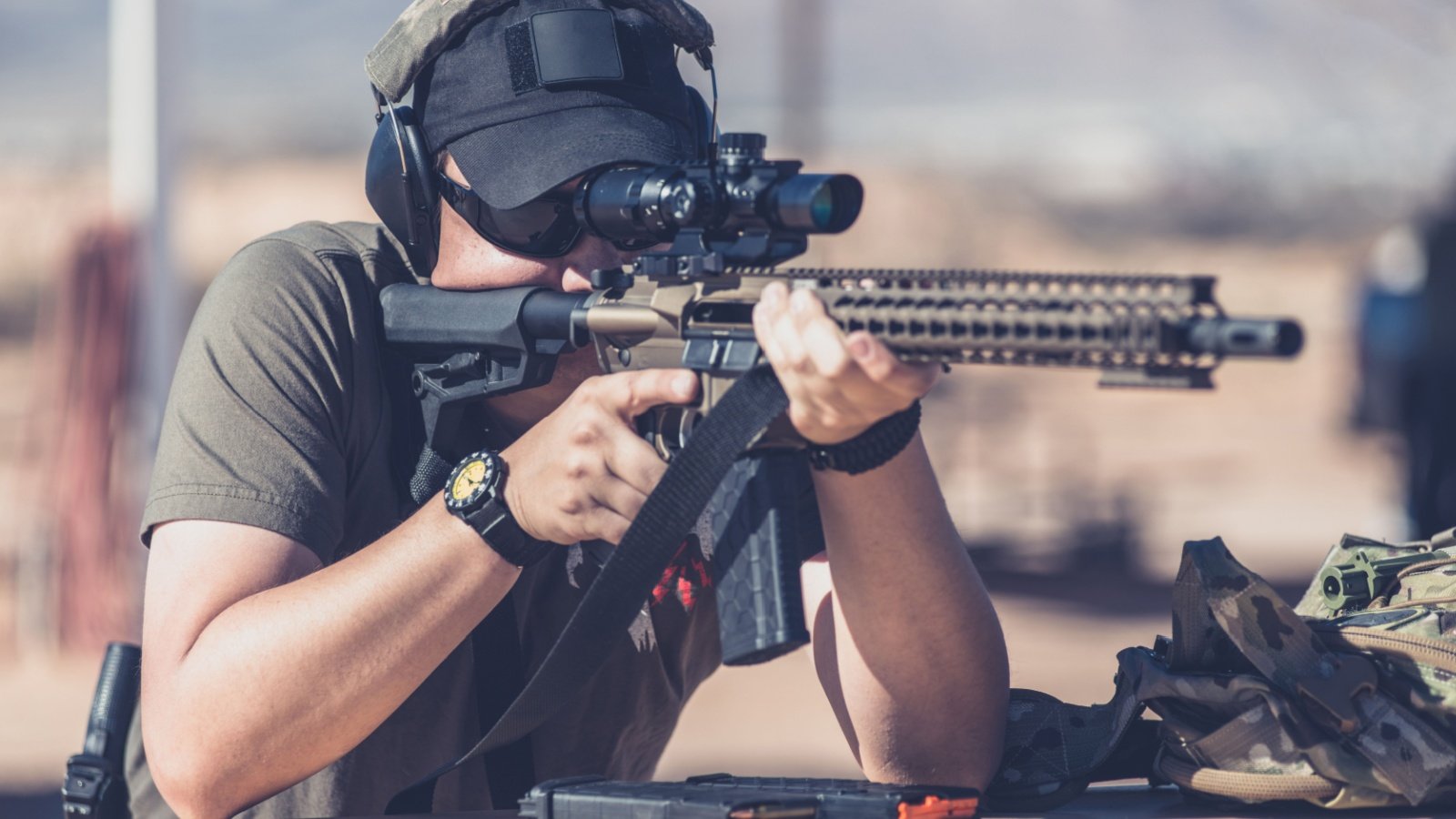 Man shooting assault style rifle at shooting range gun weapon firearm Ambrosia Studios Shutterstock