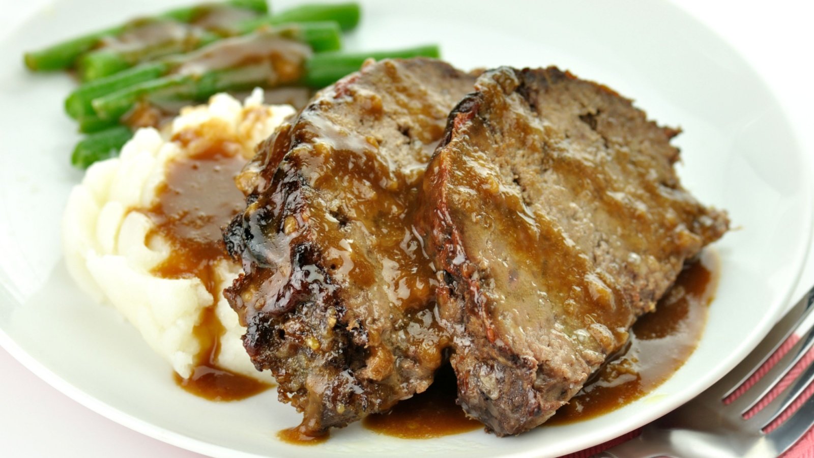 Meat loaf with mashed potatoes and green beans and gravy Svetlana Foote Shutterstock