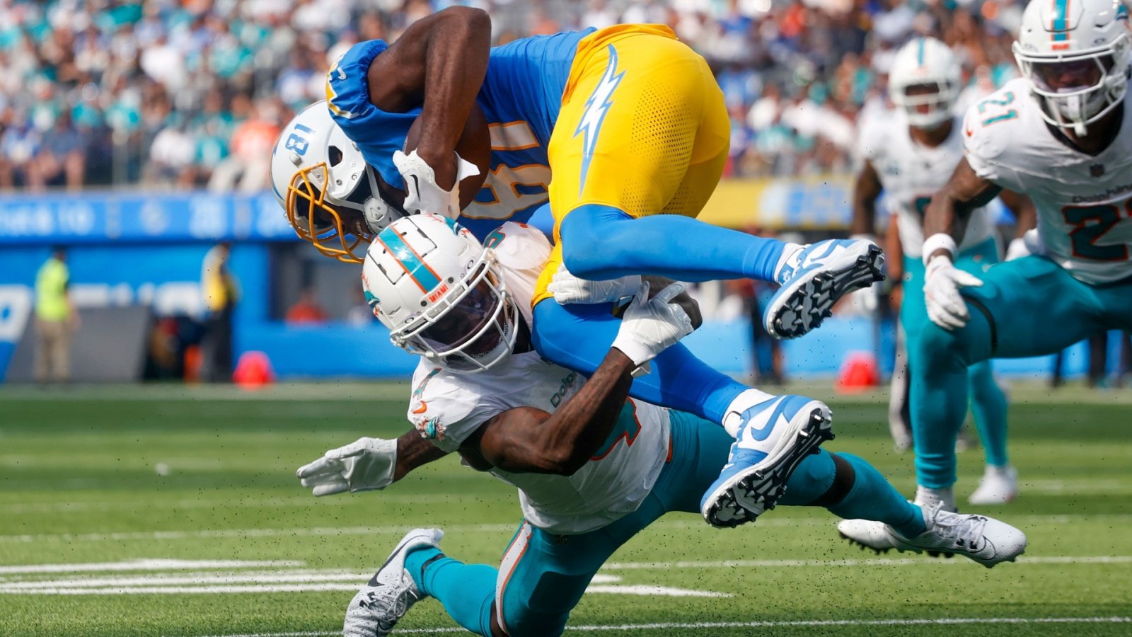 Mike Williams (TOP) is brought down by Miami Dolphins cornerback Kader Kohou football Ringo Chiu Shutterstock