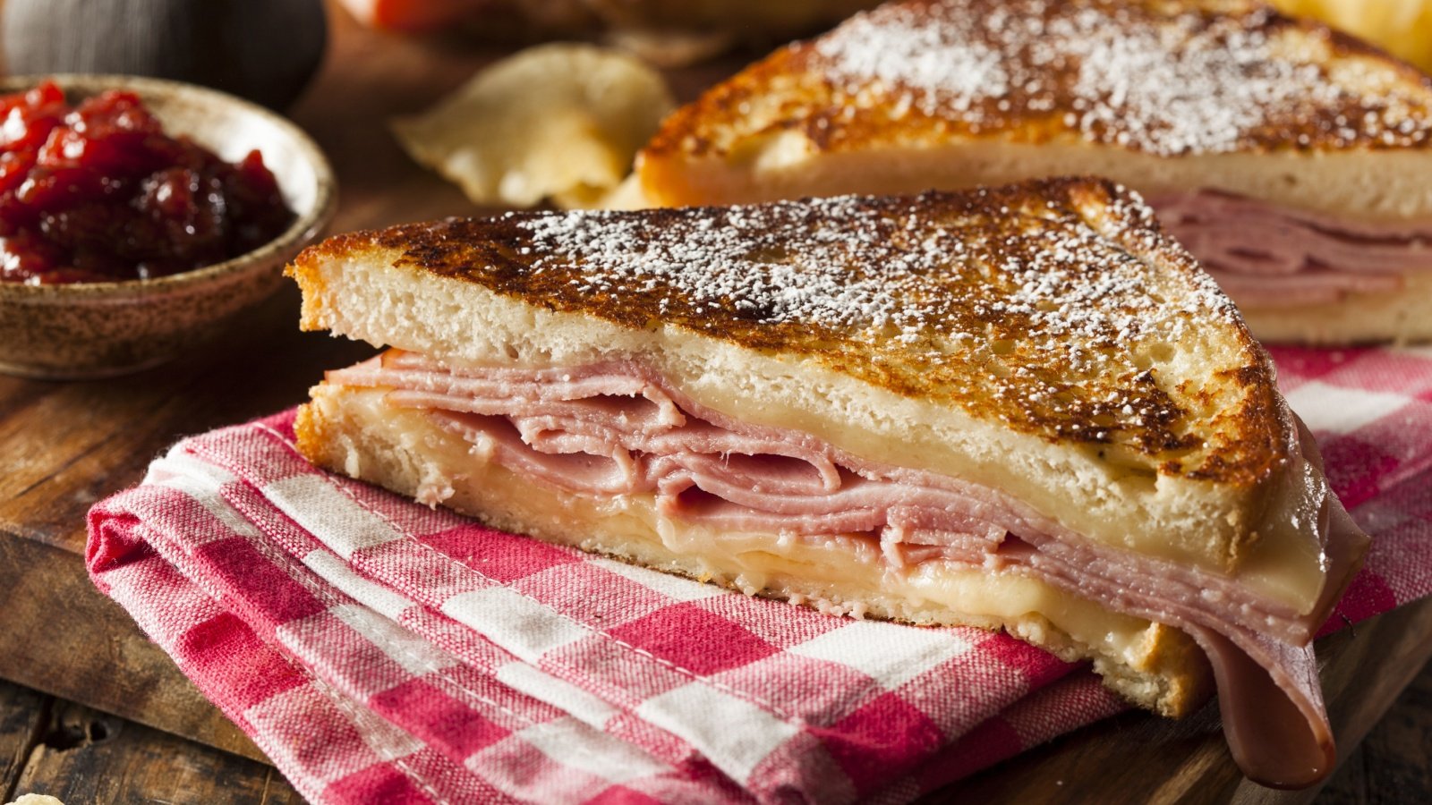 Monte Cristo Sandwich with Ham and Cheese powdered sugar and berry sauce Brent Hofacker Shutterstock