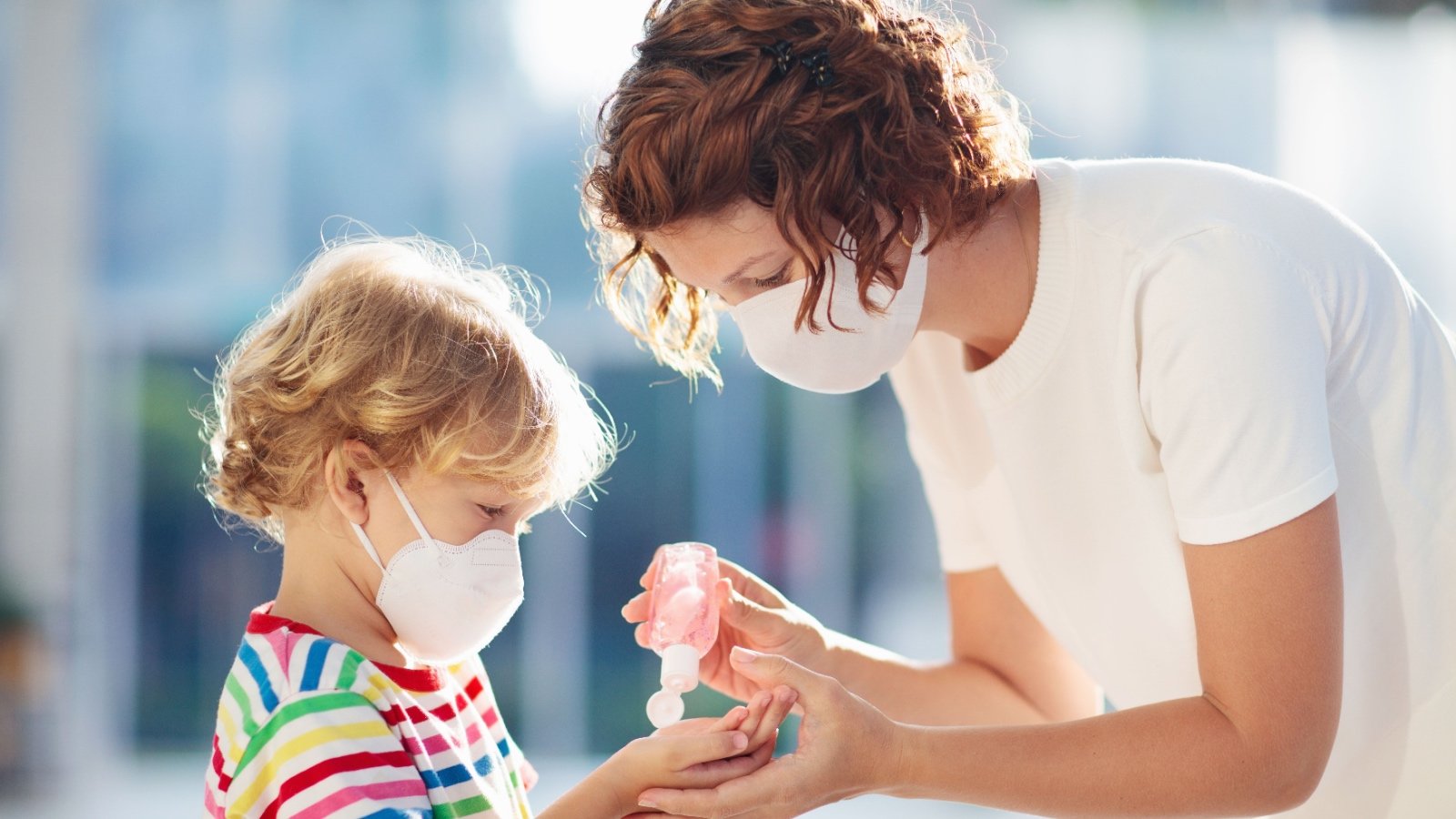 Mother and child sharing hand sanitizer with face mask FamVeld Shutterstock