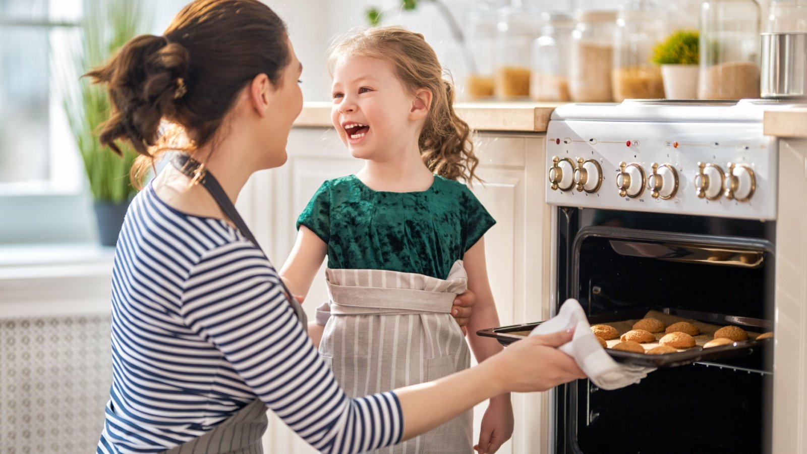 Mother daughter child bake cookies oven kitchen Yuganov Konstantin Shutterstock