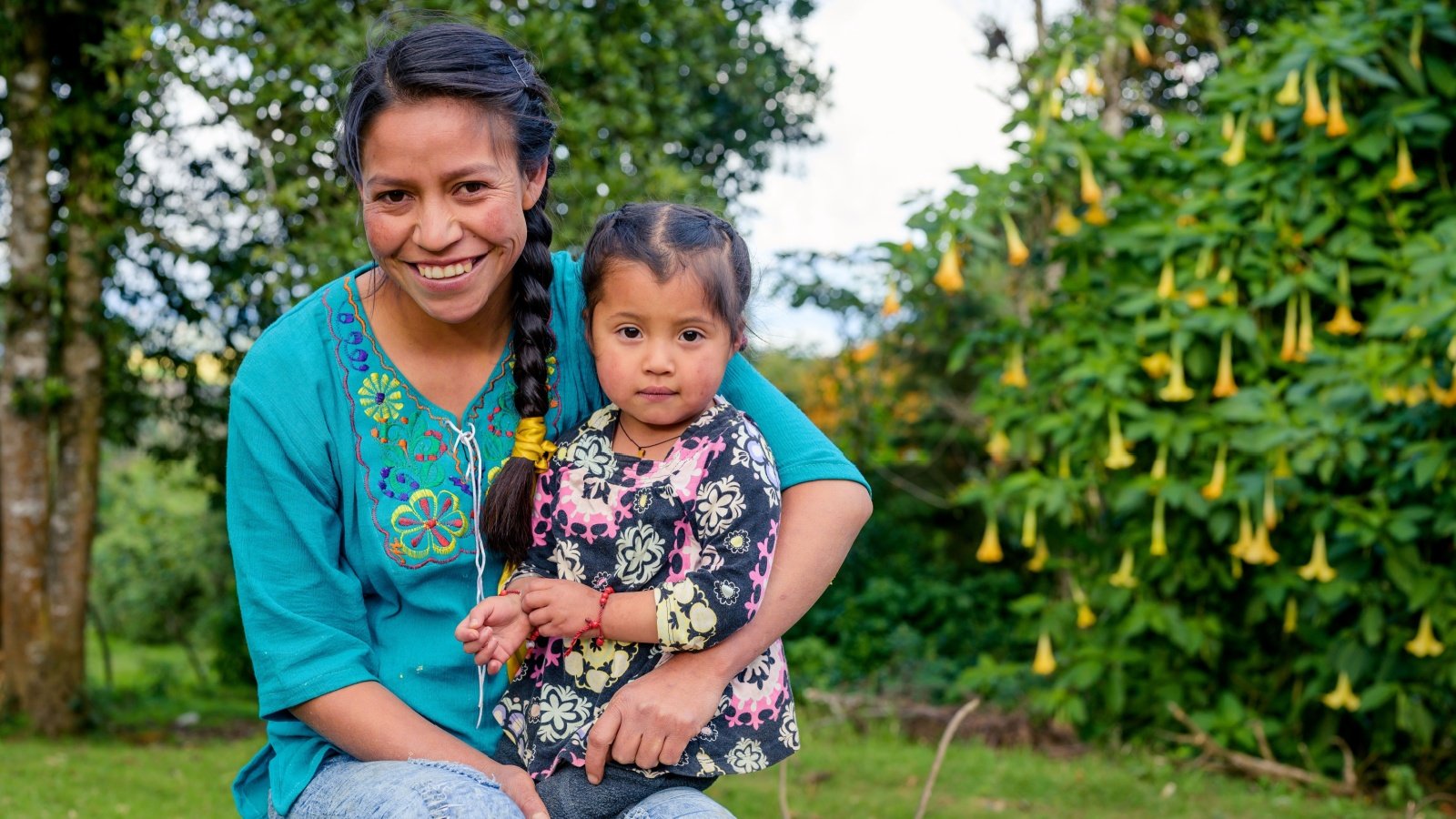 Native American mother and daughter braid backyard outdoors SALMONNEGROSTOCK Shutterstock