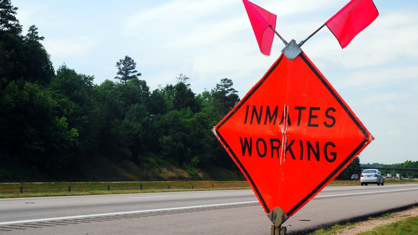 Orange highway sign inmates working prisoners jail James Kirkikis Shutterstock