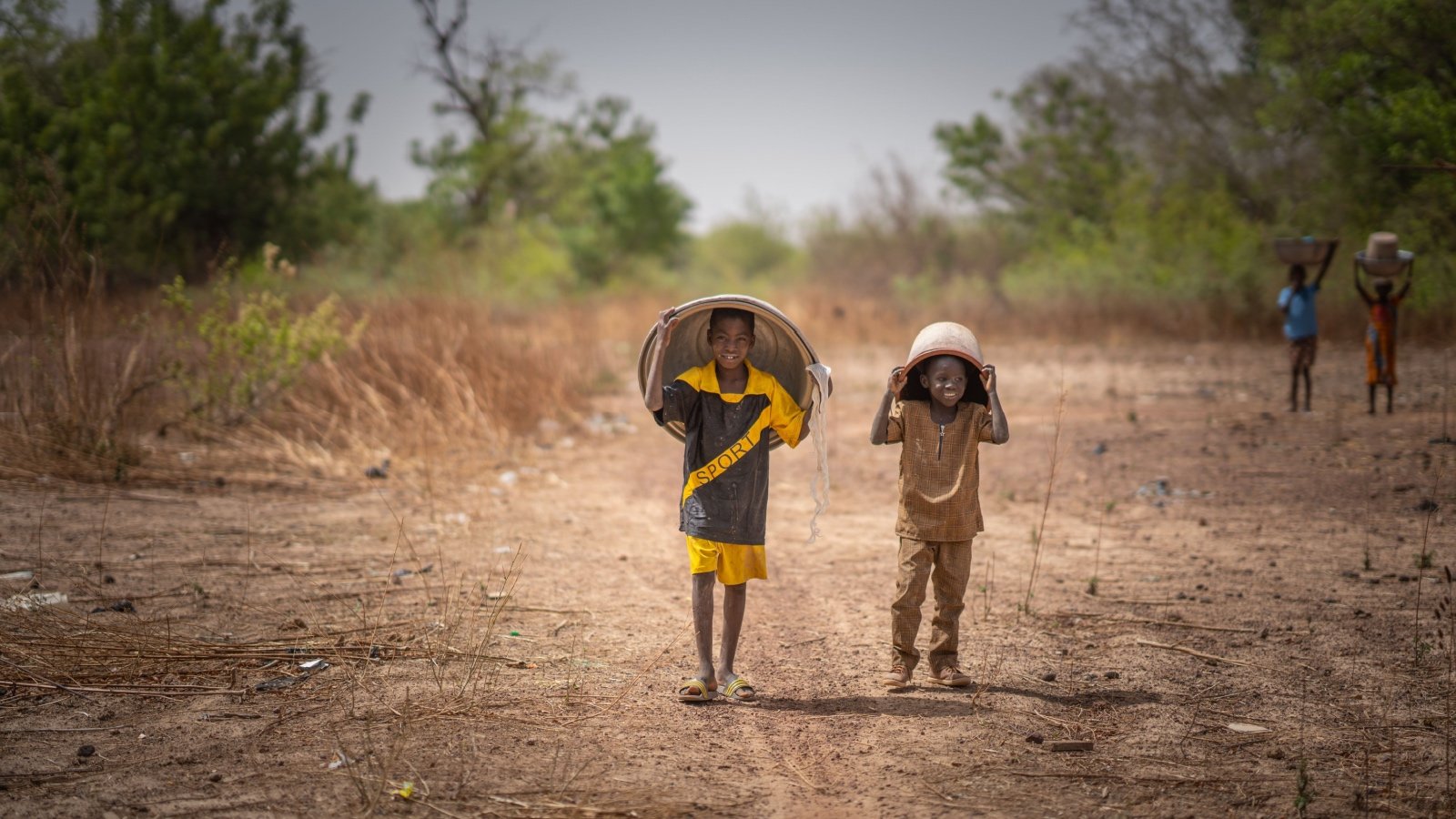 Ouagadougou Burkina Faso Africa children holding bucket of water Allowosman Shutterstock Ouagadougou Burkina Faso Africa children holding bucket of water Allowosman Shutterstock