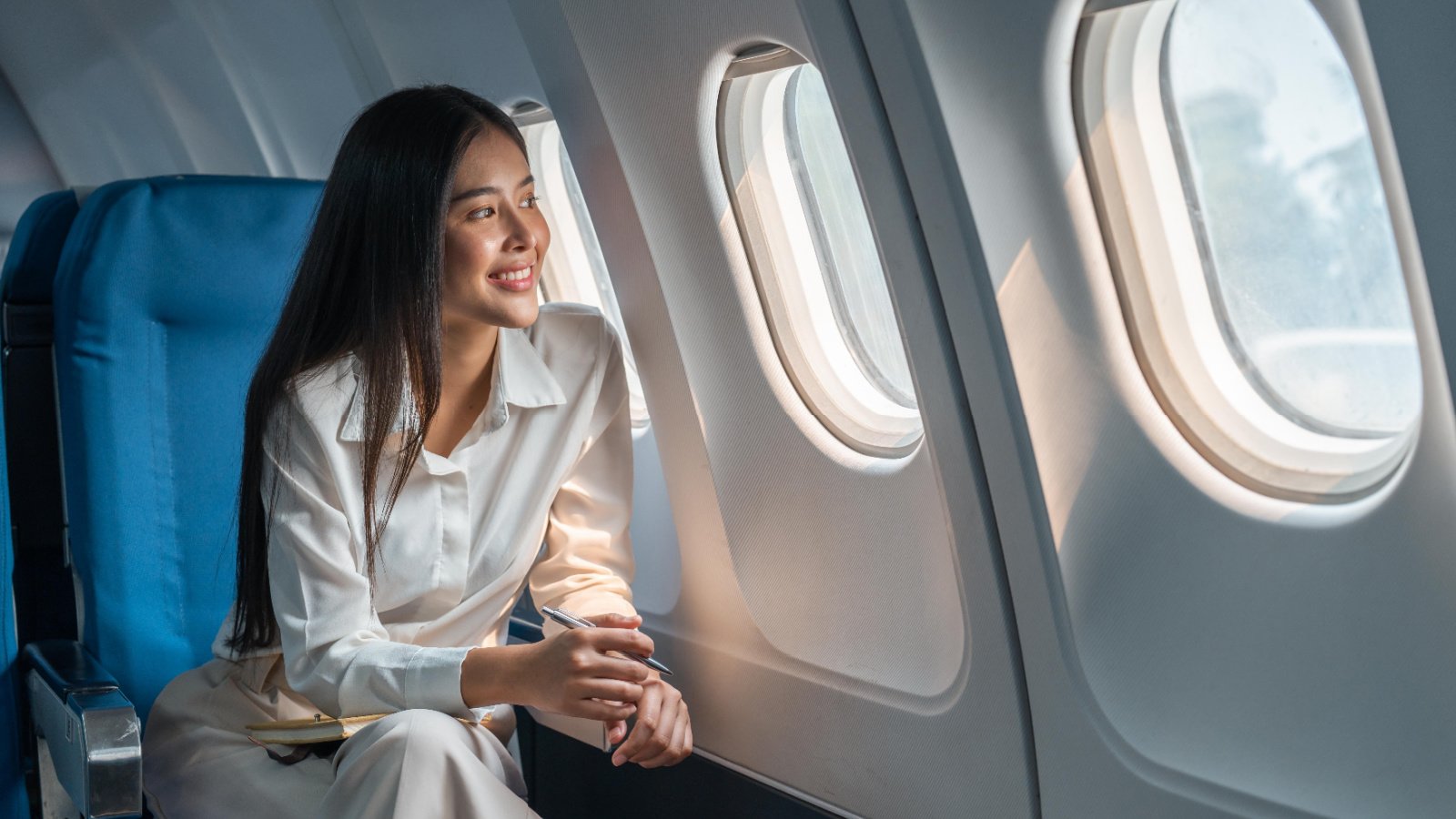 POC Woman Airplane plane passenger window seat Natee Meepian shutterstock