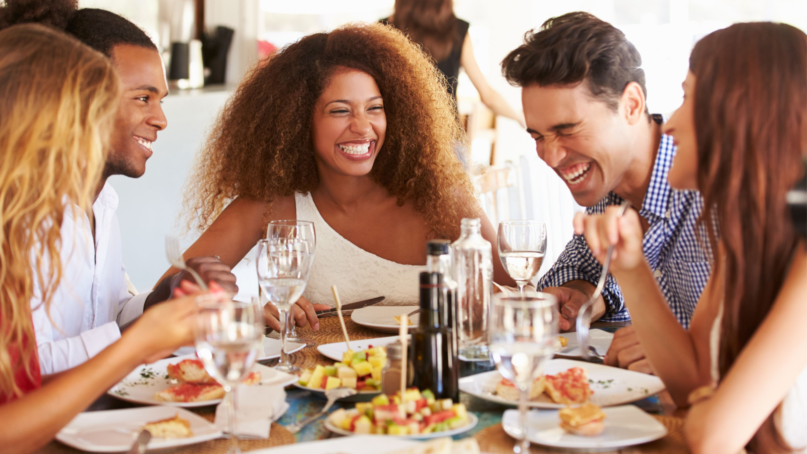 POC Woman Friends Eating Out Dinner Restaurant Monkey Business Images Shutterstock