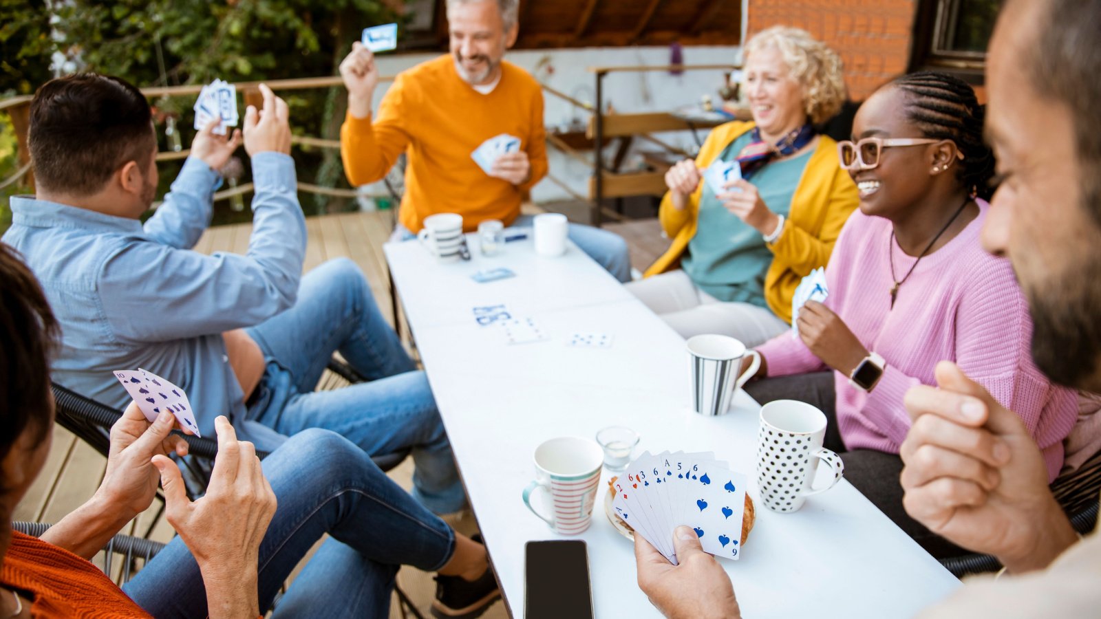 POC friends card game play relax social outdoor Pearl PhotoPix Shutterstock