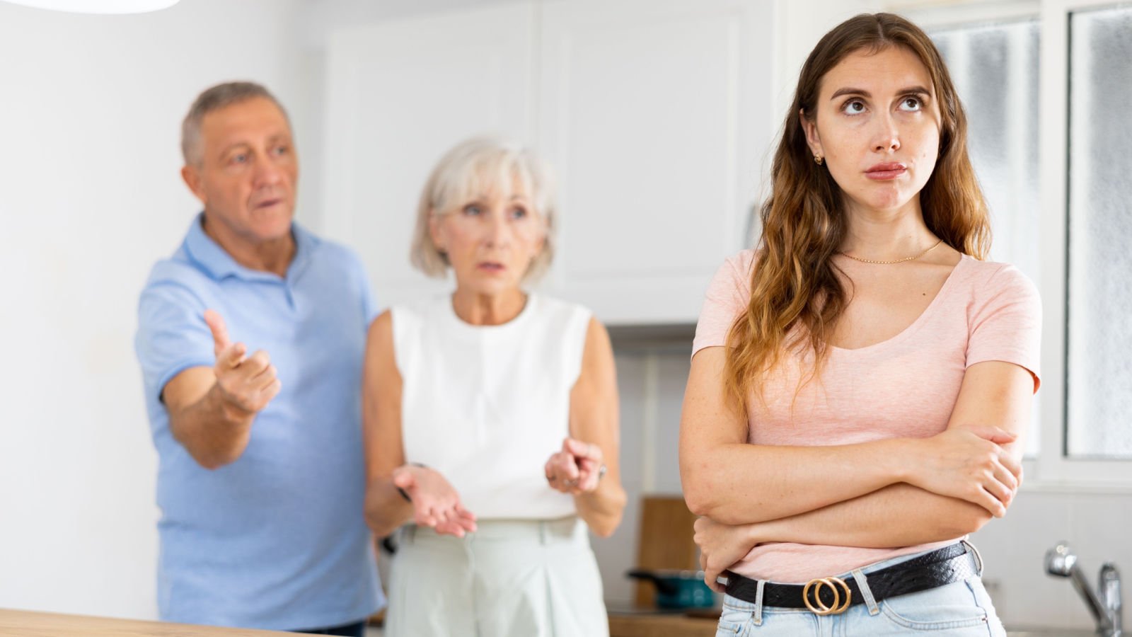 Parents lecturing their adult daughter at home mother father 3 way bearfotos shutterstock