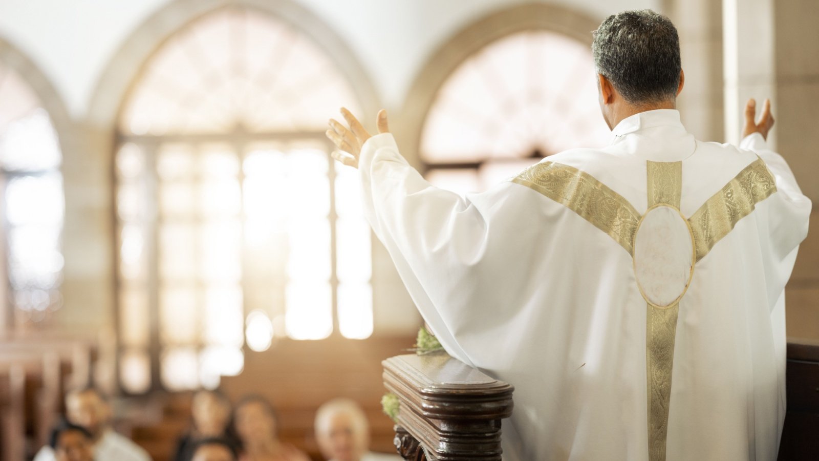 Pastor church and man praying for his congregation to god religion PeopleImages YuriA Shutterstock