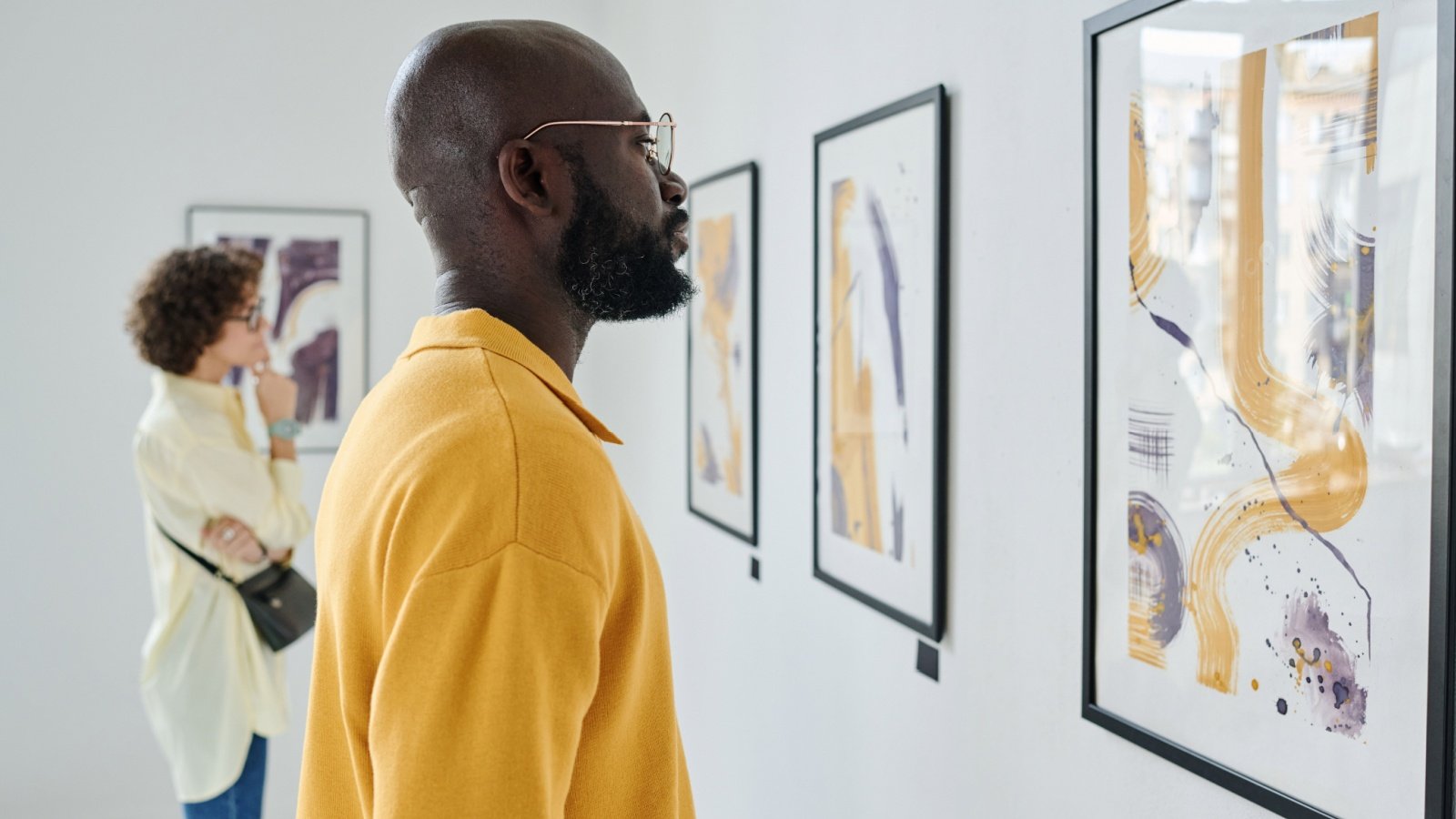 People visiting art exhibition at gallery museum AnnaStills Shutterstock