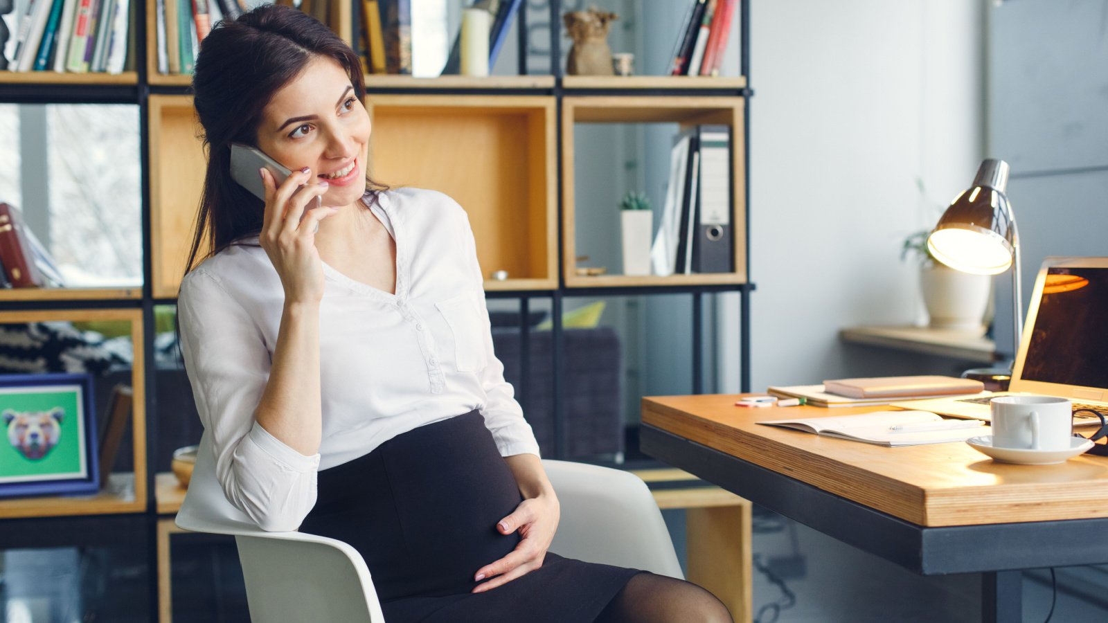 Pregnant business woman working at office motherhood sitting call viktoriia hnatiuk shutterstock