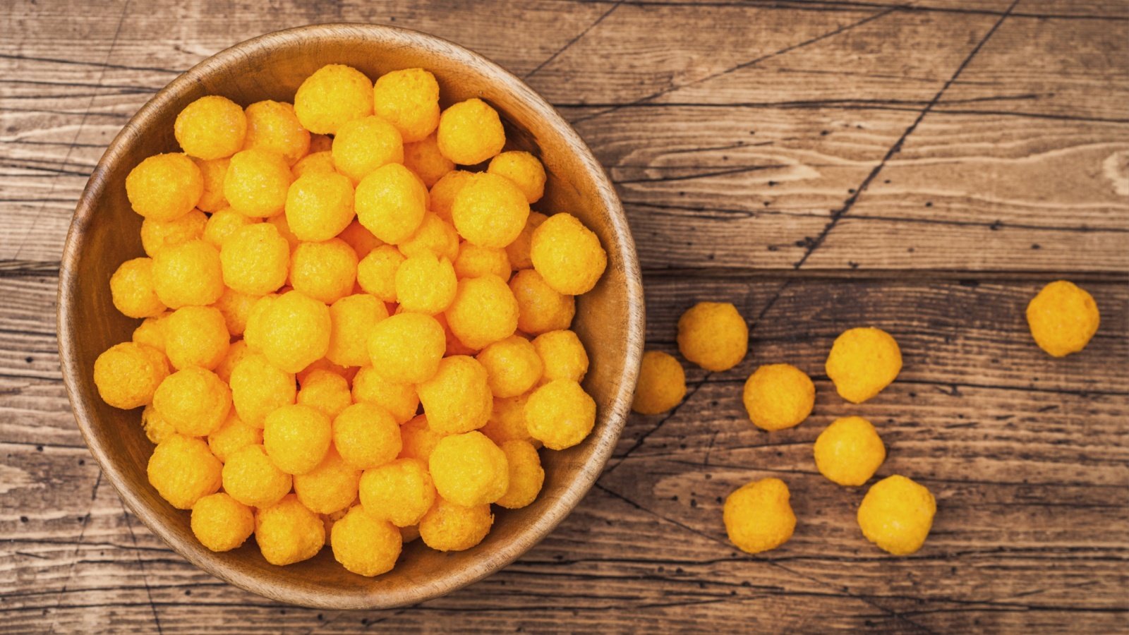 Puffed golden cheese balls doodles classic kids snack DenisMArt Shutterstock