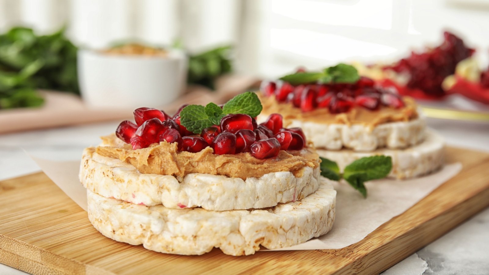 Puffed rice cakes with peanut butter pomegranate healthy snack New Africa Shutterstock