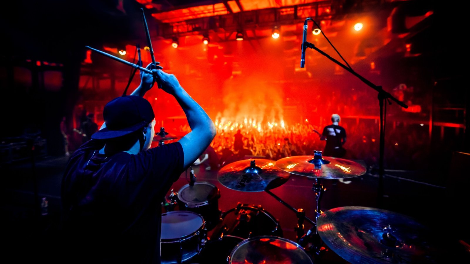 Rock concert poster drummer plays drums on stage Gallks Shutterstock