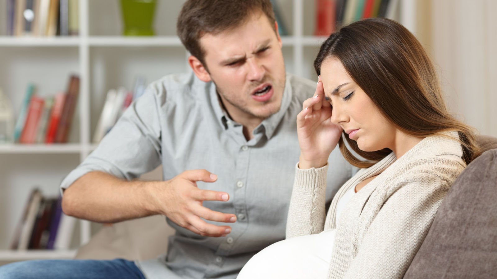 Sad pregnant woman fighting with her husband sitting on a sofa at home couple antonio guillem shutterstock