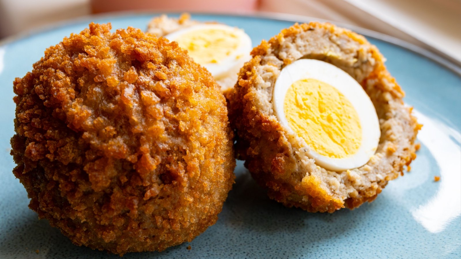 Scotch eggs boiled egg with sausage and breadcrumbs fried street food barmalini Shutterstock