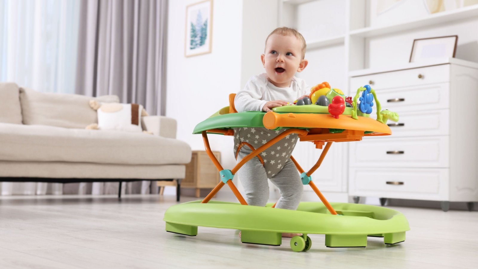 Small child first steps with baby walker toddler kid infant New Africa Shutterstock