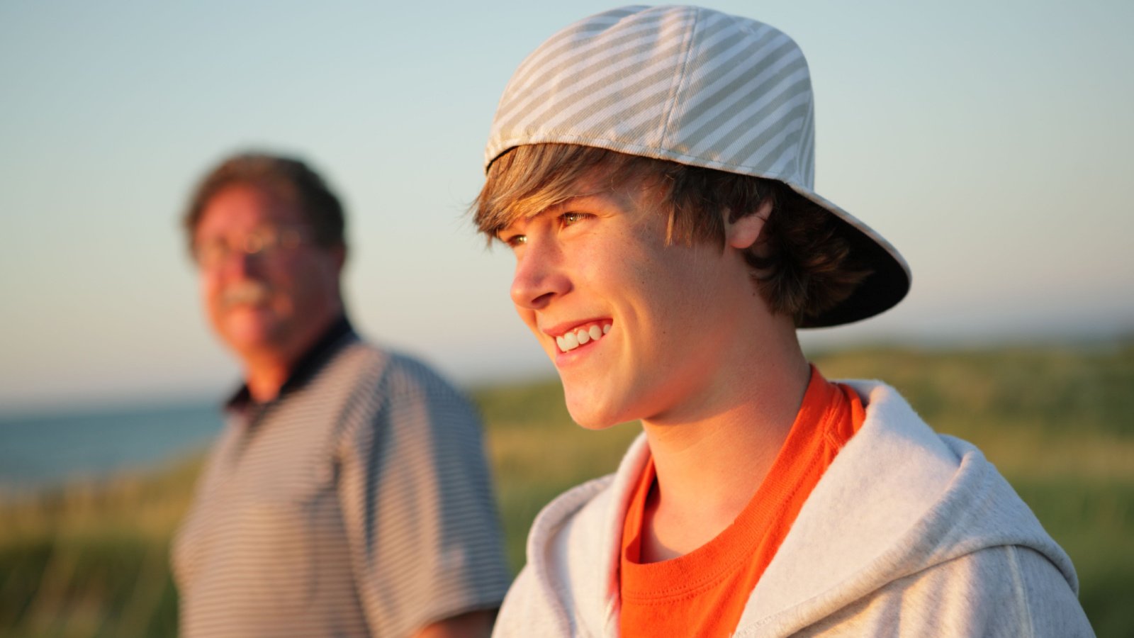 Smiling teenage boy with father outdoors child kid suzanne tucker shutterstock