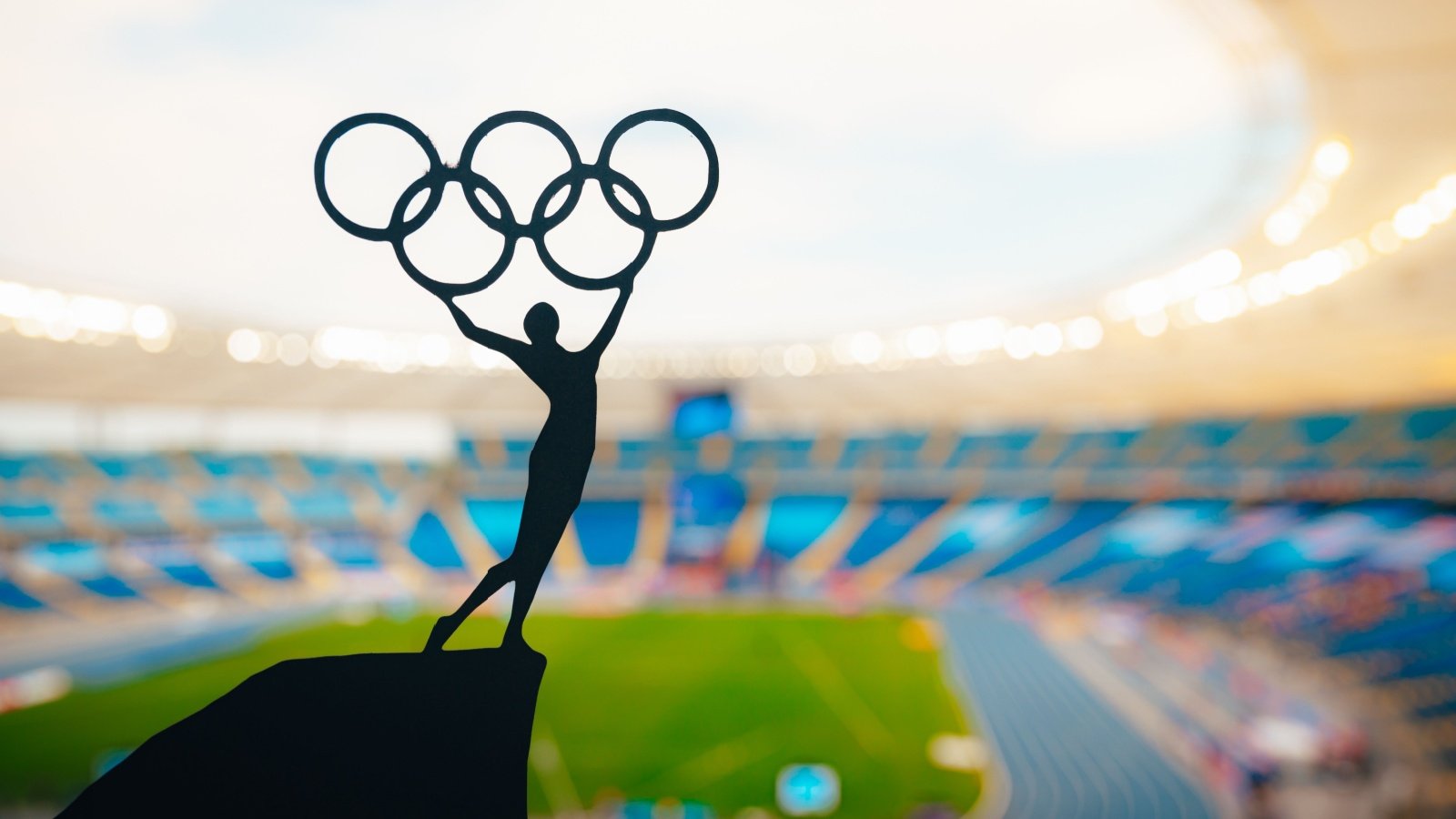 Statue of athlete holding olympic circle stadium sports olympics kovop Shutterstock