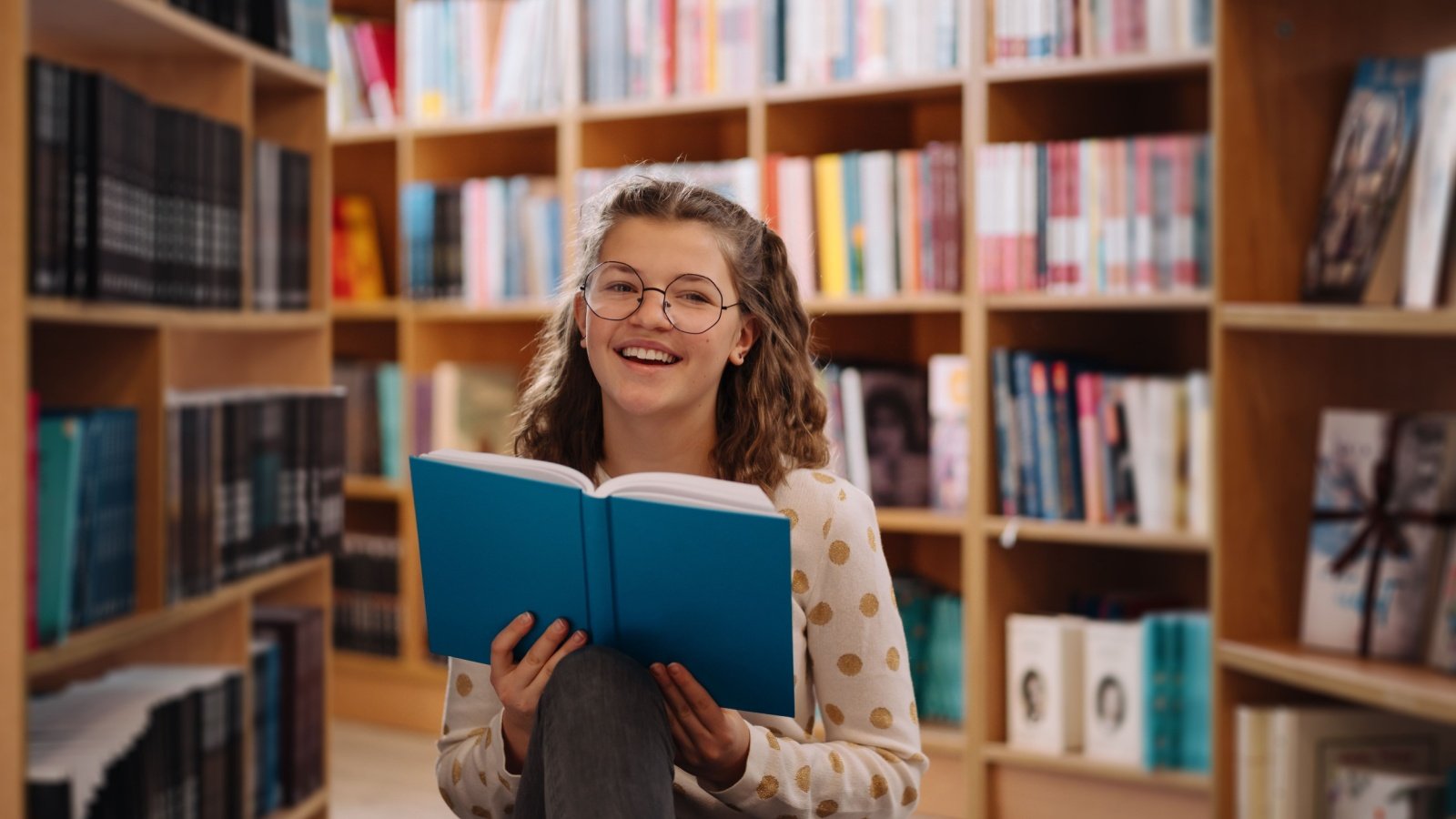 Teen Girl Bookstore Reading with Glasses Arthur Bargan Shutterstock