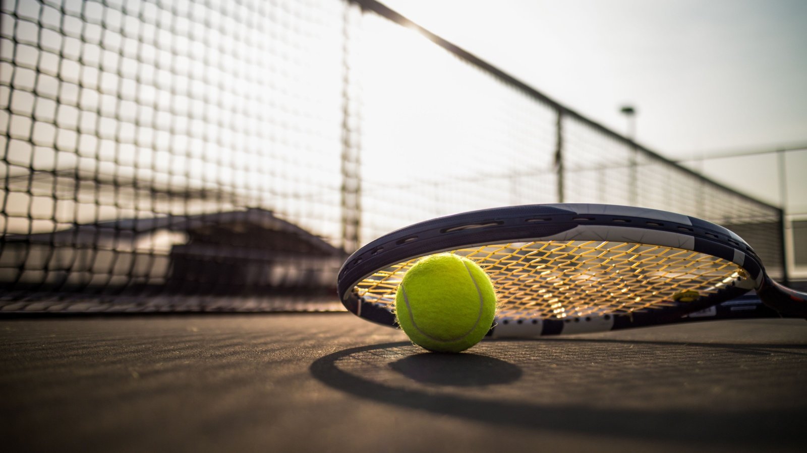 Tennis ball and racket on court sports fitness icedmocha Shutterstock