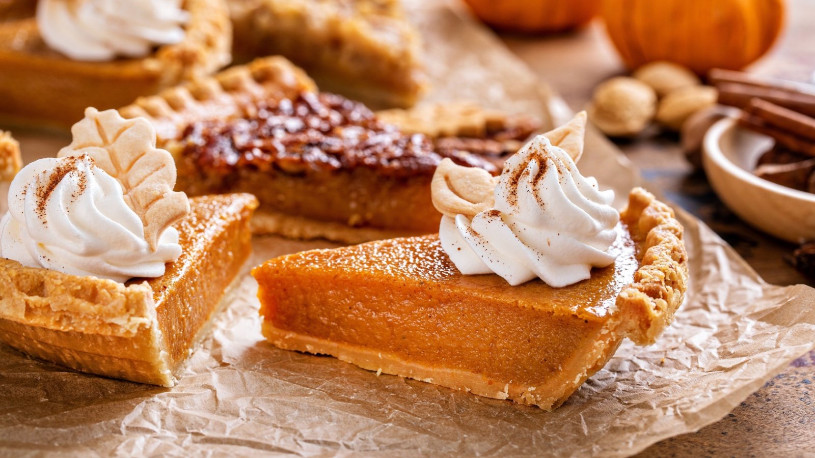 Traditional Thanksgiving pies slices on parchment paper, pumpkin and pecan pie Elena Veselova Shutterstock