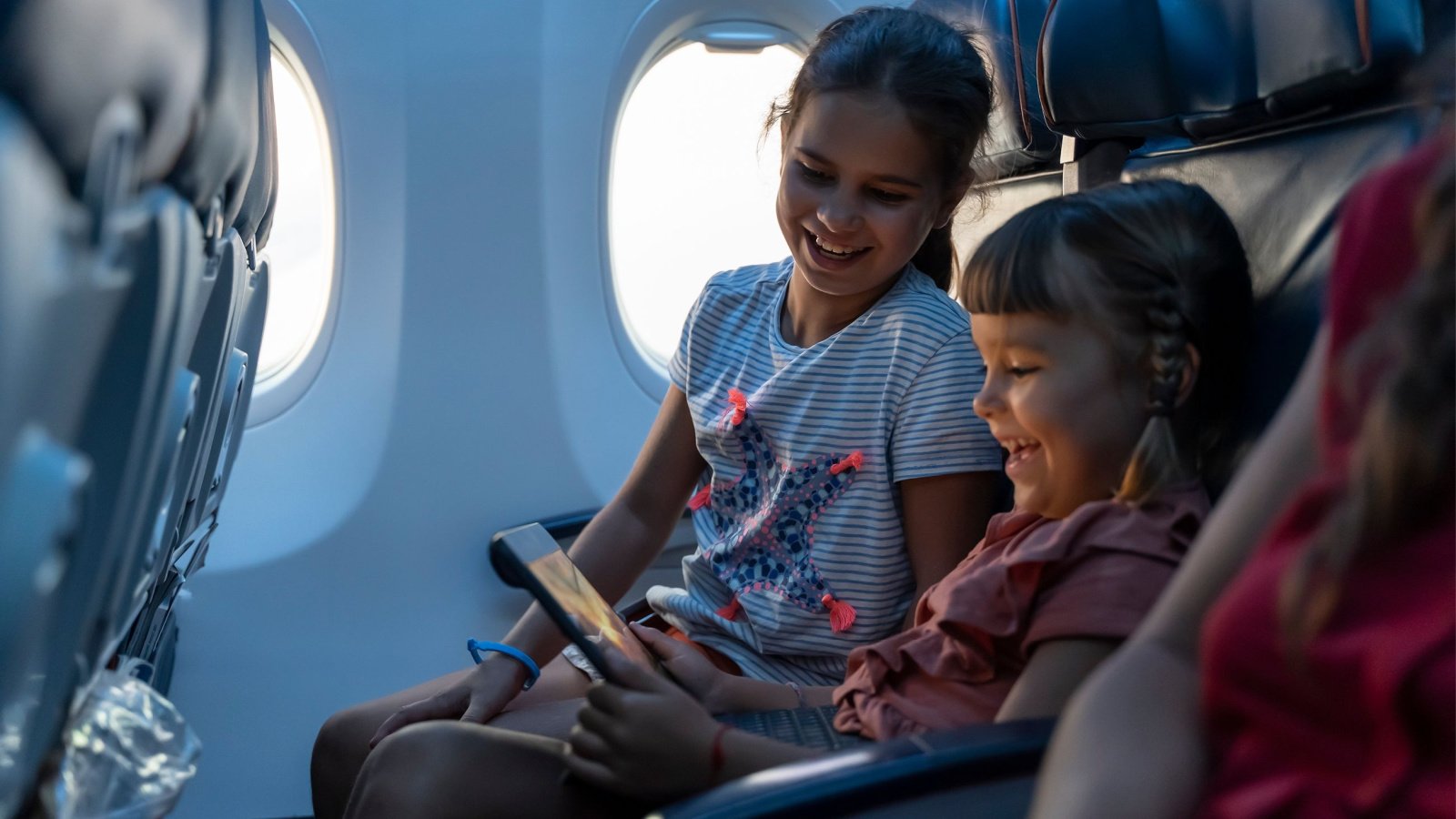 Travel Children girls airplane parenting Alex Desanshe Shutterstock