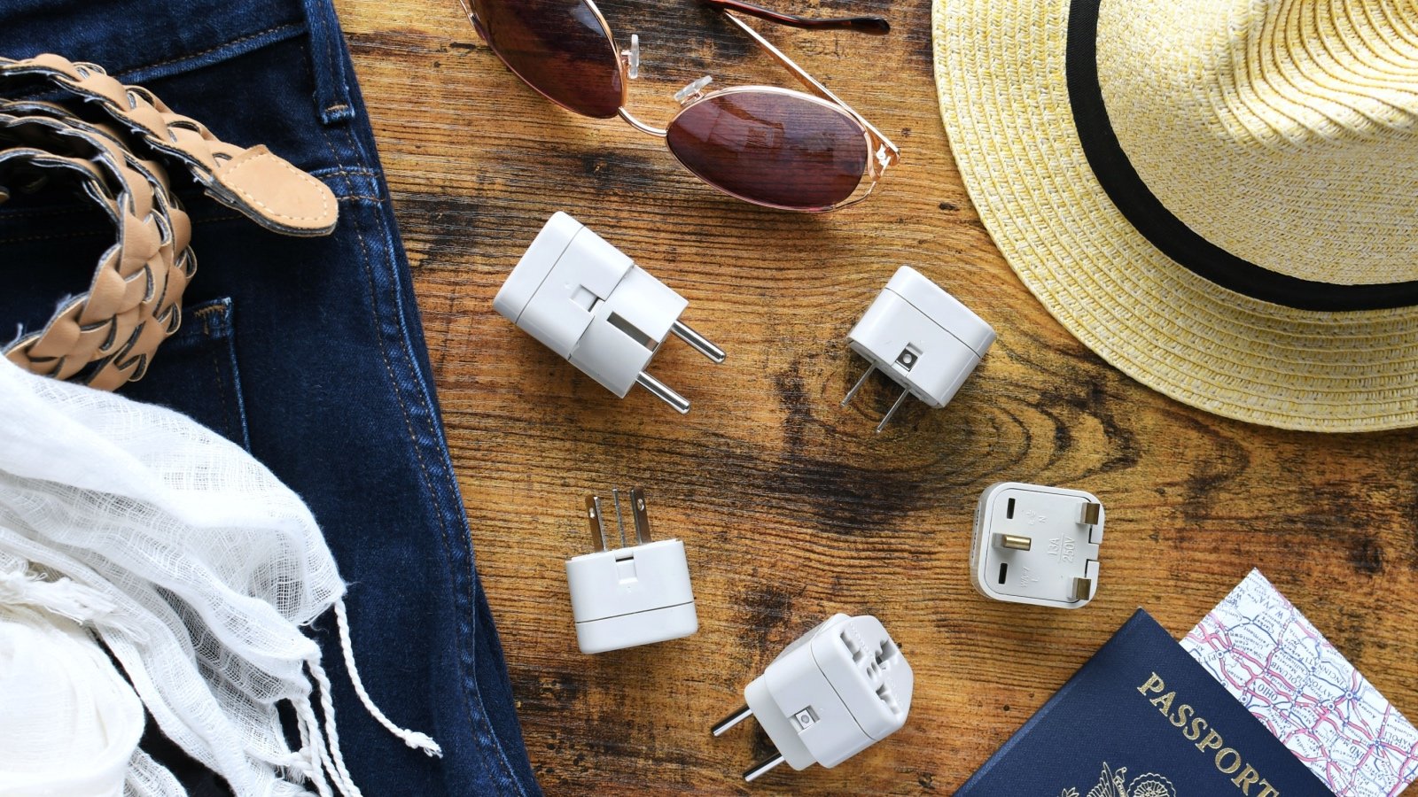 Travel adapter sunglasses hat passport belt and scarf MargJohnsonVA Shutterstock