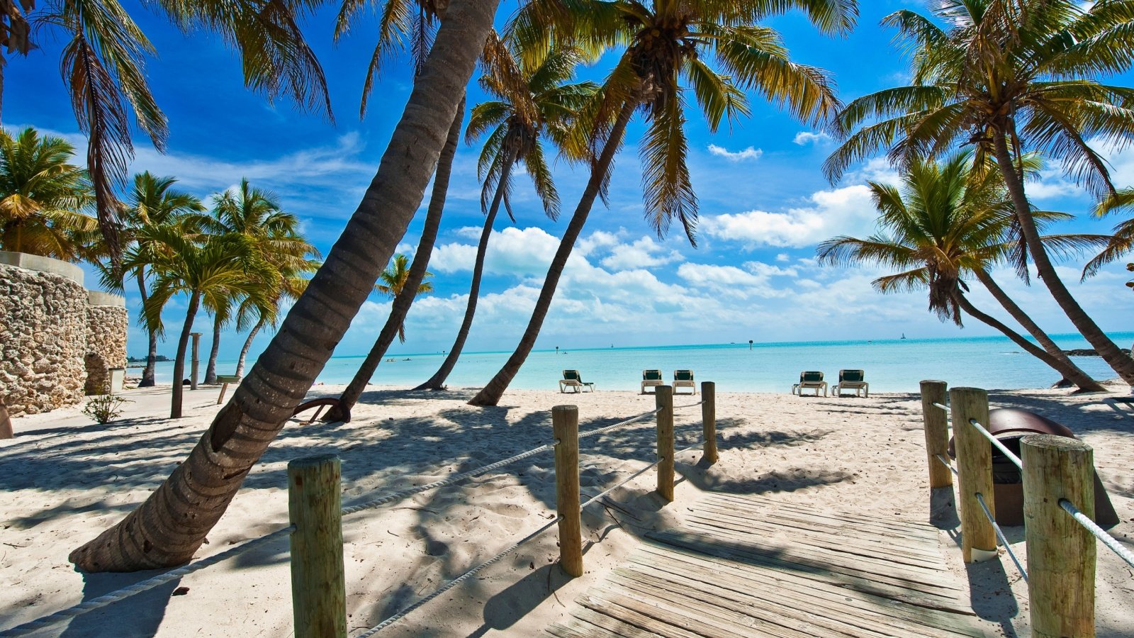 Tropical footbridge to the beach Key West Florida Keys palm trees ocean Stockdonkey Shutterstock