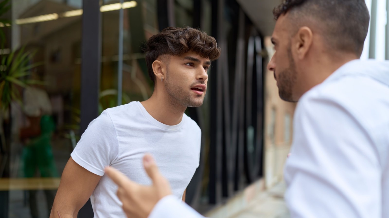 Two males arguing outside fight disagreement confrontation altercation upset angry mad Krakenimagescom Shutterstock