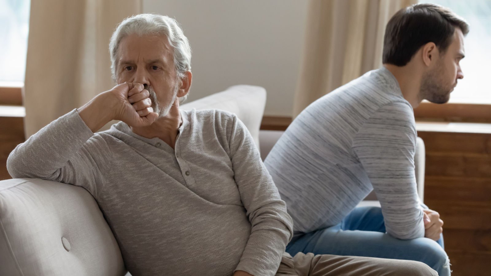 Unhappy mature father and adult son not taking after fight fizkes shutterstock