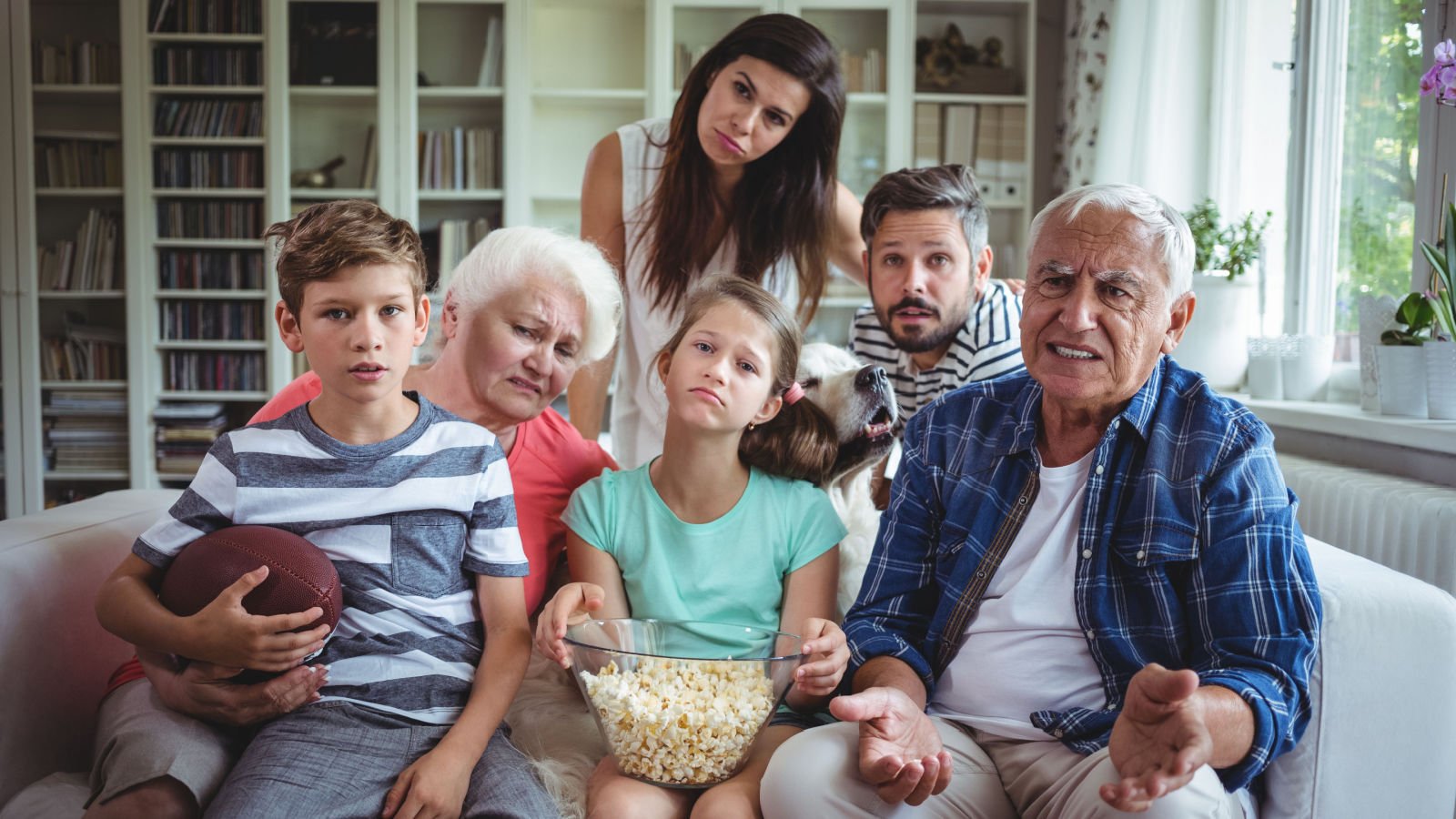 Unhappy multi generation family watching soccer match on television wavebreakmedia shutterstock