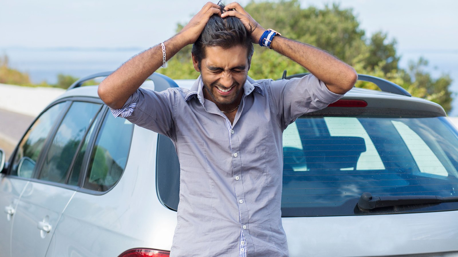 Upset driver parking after car accident crying hands on head hbrh shutterstock