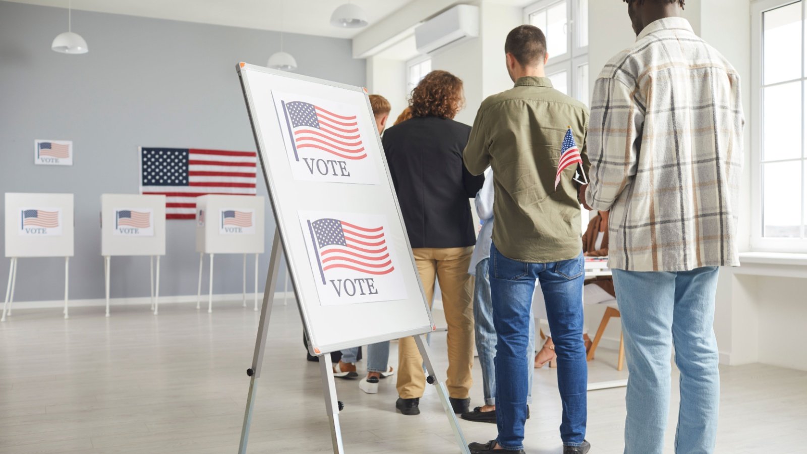 Voters stand in line at the voting station election ballot Studio Romantic Shutterstock