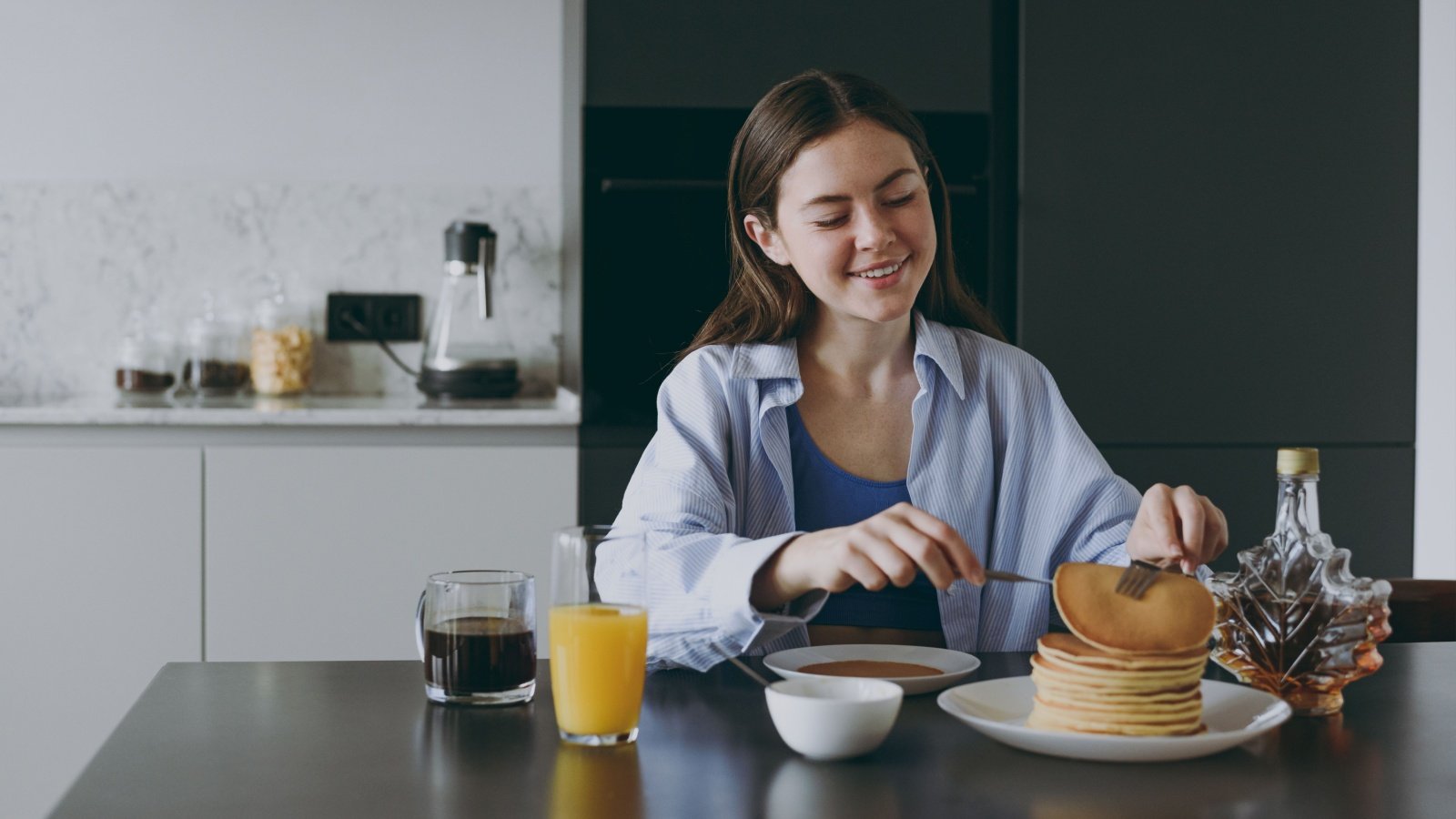 Woman Breakfast Pancakes Juice Maple Syrup Coffee ViDI Studio Shutterstock