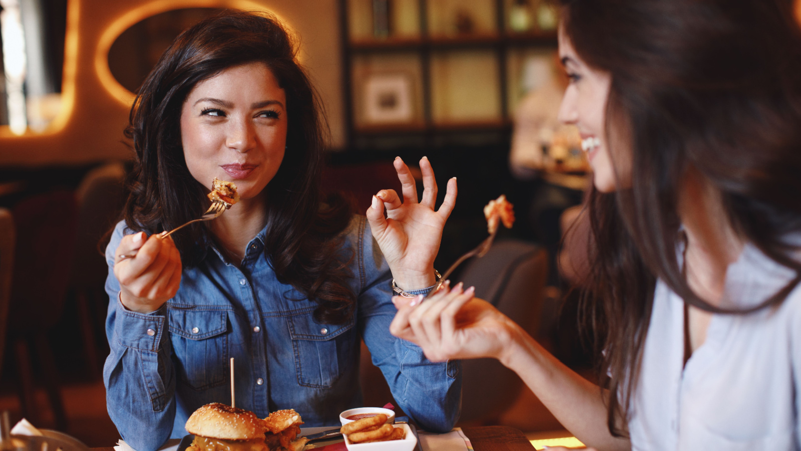 Woman Friends Eating Out Restaurant Dinner djile Shutterstock