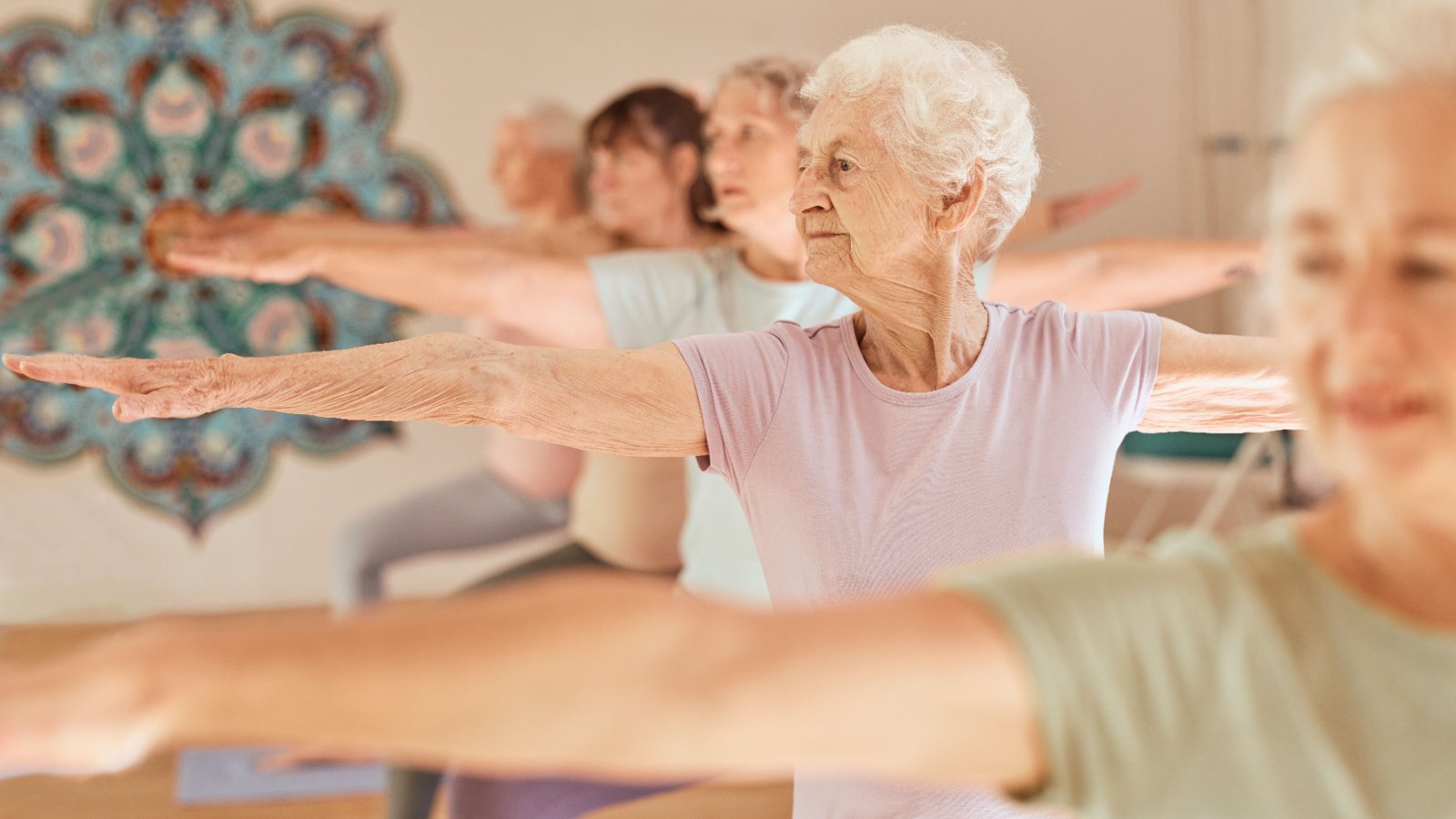 Woman Group Gym Yoga Stretch Meditation Senior Mature Self Care PeopleImages.com Yuri A Shutterstock