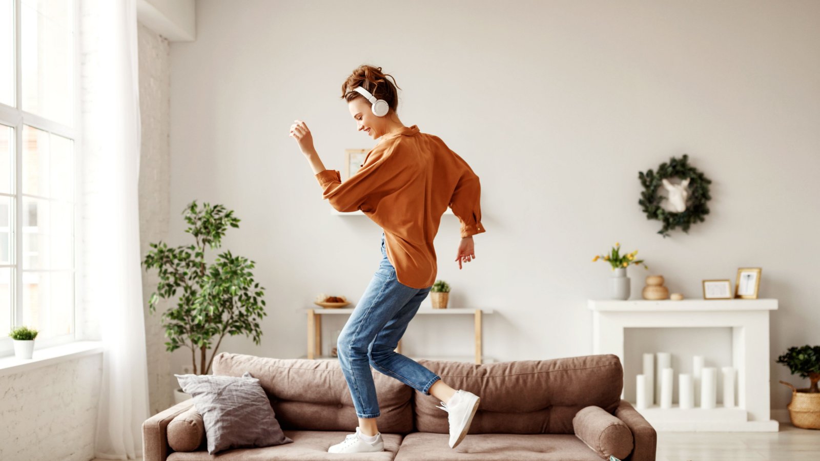 Woman Headphones Listening to Music Dancing Living Room House Evgeny Atamanenko Shutterstock