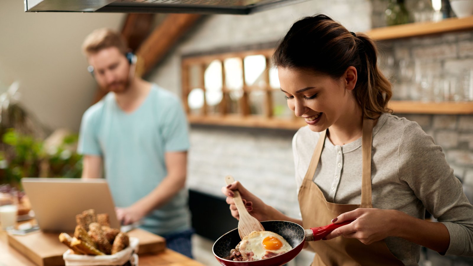 Woman Kitchen Cooking Eggs Breakfast Drazen Zigic Shutterstock