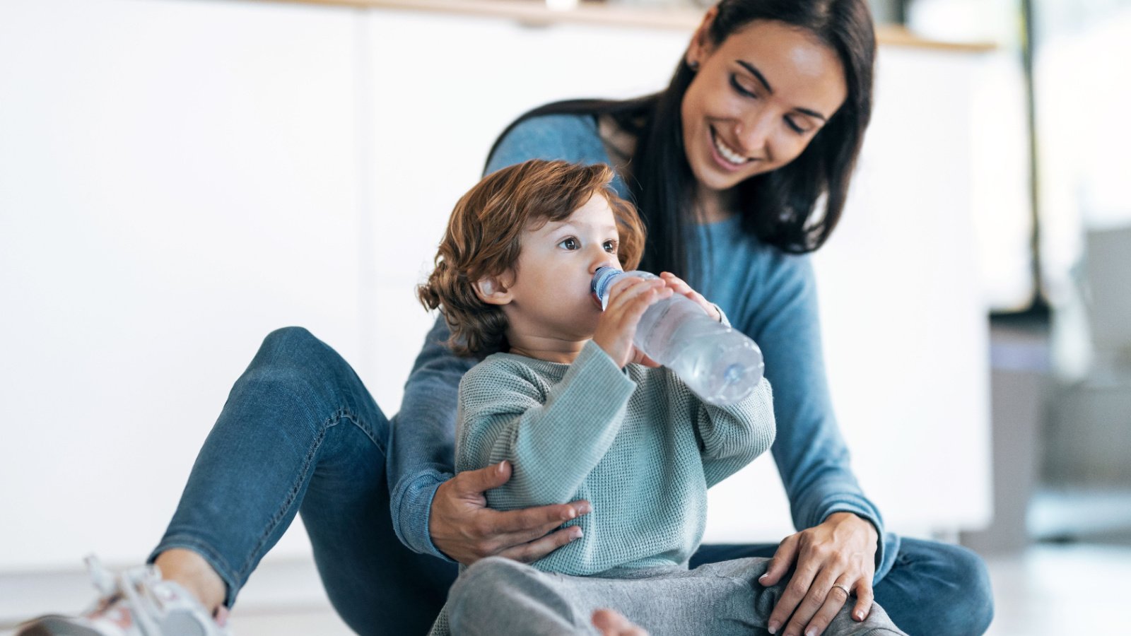 Woman Mom Baby drinking water hydration child health Josep Suria Shutterstock