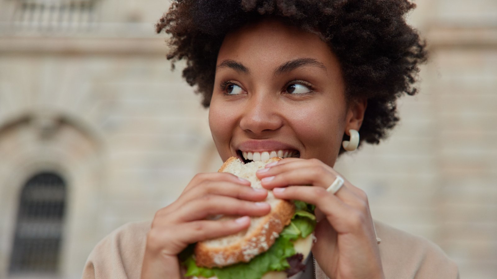 Woman POC Eating Sandwich Lunch WAYHOME studio Shutterstock