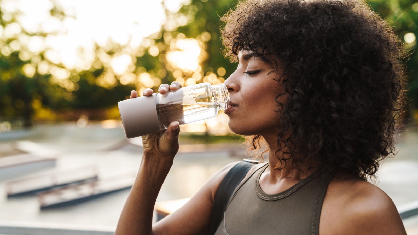 Woman POC drinking water hydration bottle recycle health exercise Dean Drobot Shutterstock