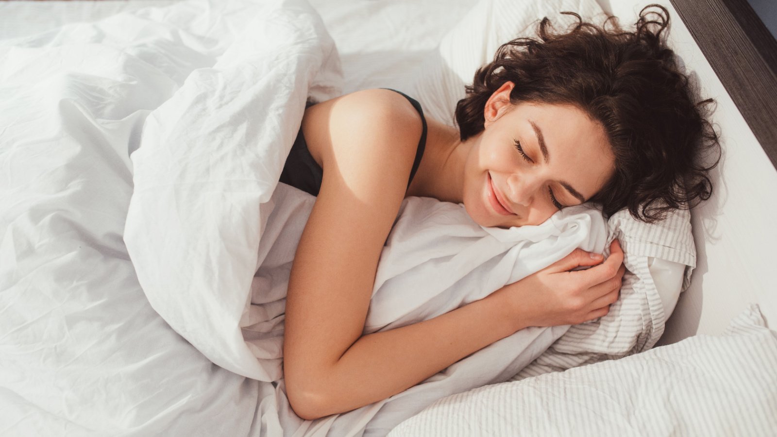 Woman Sleeping Smiling bed sheets Olena Yakobchuk Shutterstock