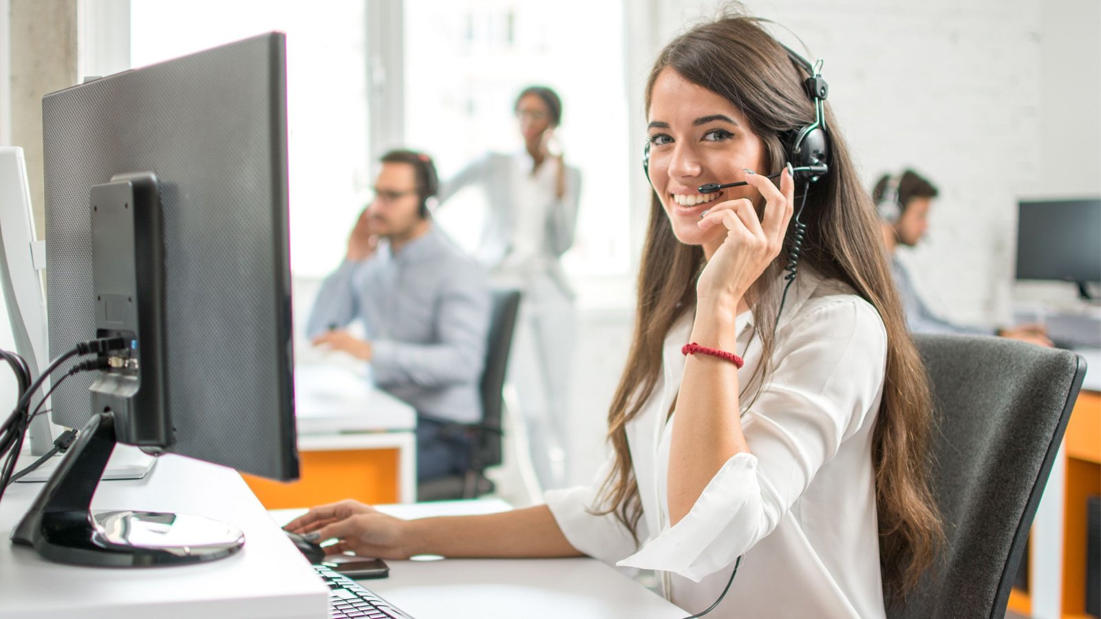 Woman Virtual Assistant Receptionist Office headset Bojan Milinkov Shutterstock